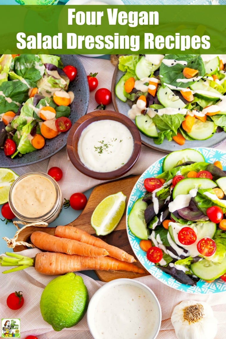 Overhead view of plates of salad and small bowls and jars of salad dressings with napkins, cutting boards, and slices of limes.