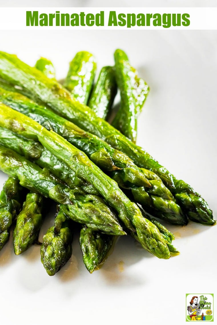 Closeup of a white plate of cooked asparagus.