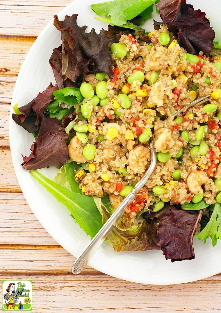 Closeup of quinoa, edamame, and shrimp salad with fork. 