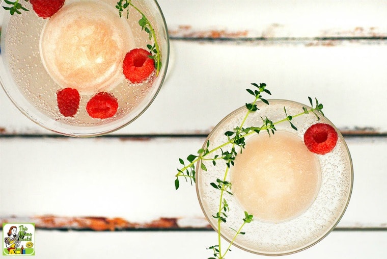 Overhead view of Frozen Wine Cocktails with raspberries and herbs.