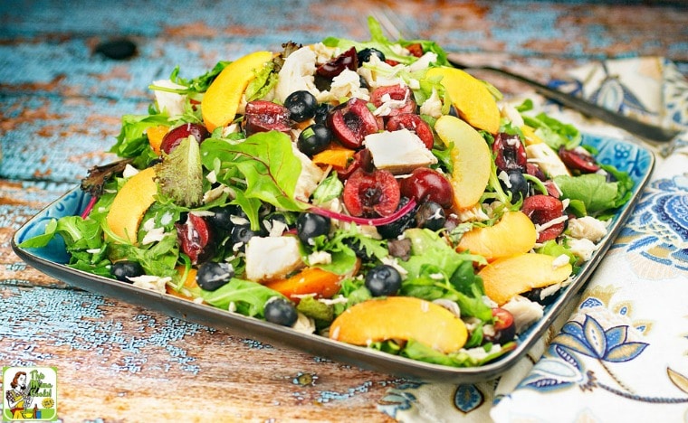 A plate of Easy Mixed Green Salad with Chicken with floral napkin.