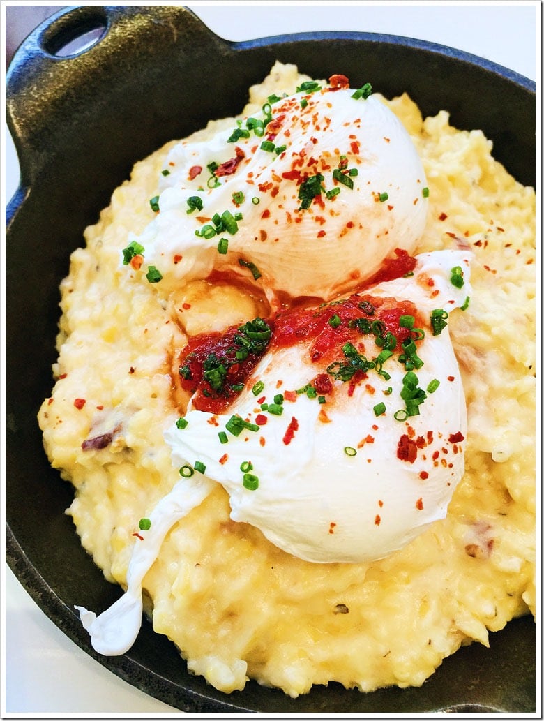 Poached Eggs on Cheddar-Bacon Grits with Tomato Jam at The Hive at 21c Museum Hotel Bentonville, Arkansas.