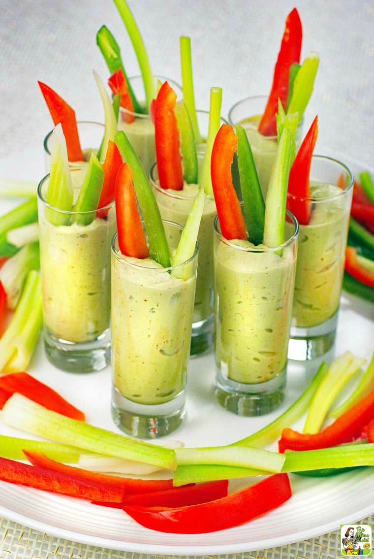 A tray of Avocado Dip Veggie Shooters with sliced vegetables.
