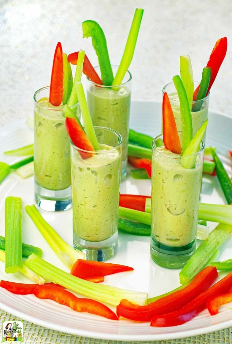 A tray of Avocado Dip Veggie Shooters with sliced vegetables on a white plate.