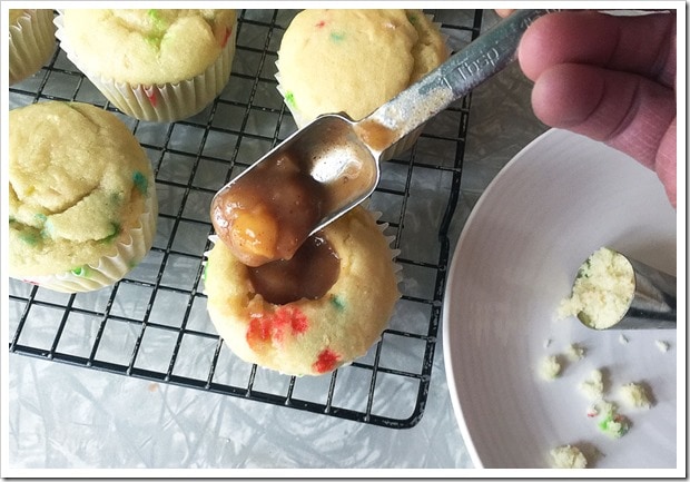 Making filled cupcakes: filling with apple pie filling.