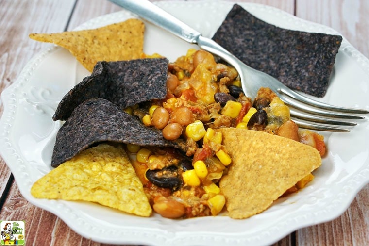A plate of Easy Nachos with chips and a fork.