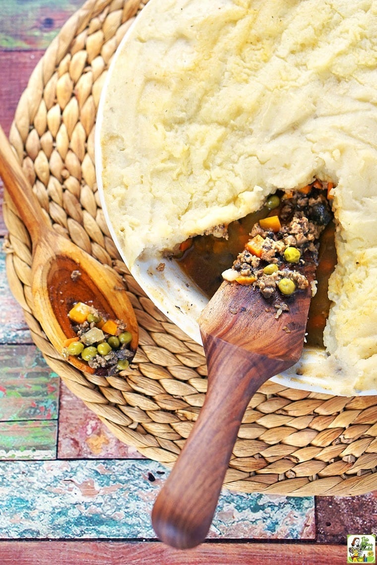 A platter of Shepherd's Pie with Ground Turkey Recipe a wooden spoon and wooden pie server