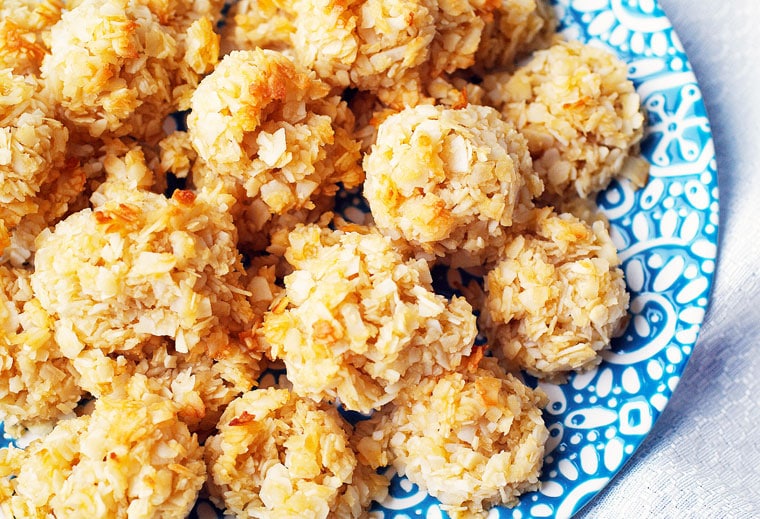 A closeup of a blue and white plate of coconut macaroon cookies.