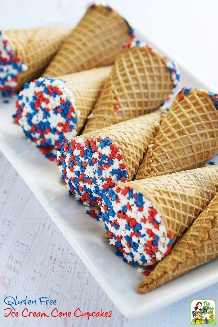 A serving plate of Ice Cream Cones Cupcakes with red white and blue star shaped sprinkles.