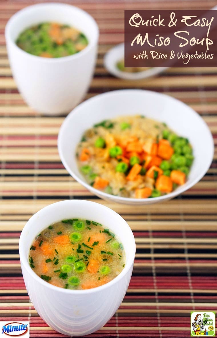 White bowls and a cup of soup with vegetables on a colorful woven mat.