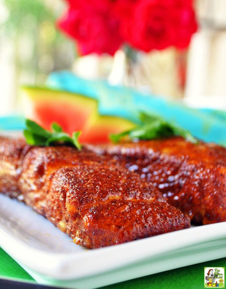 Oven baked salmon on a white plate.