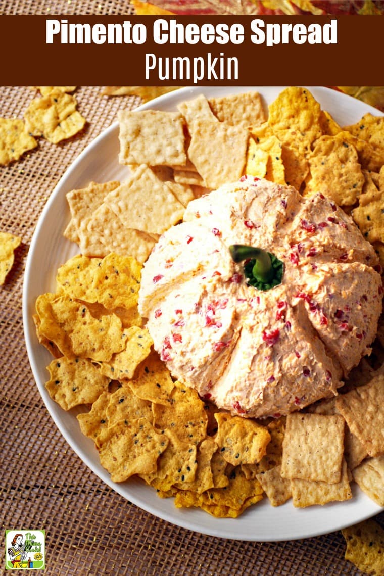 Overhead shot of a Pimento Cheese Spread Pumpkin with crackers on a plate.
