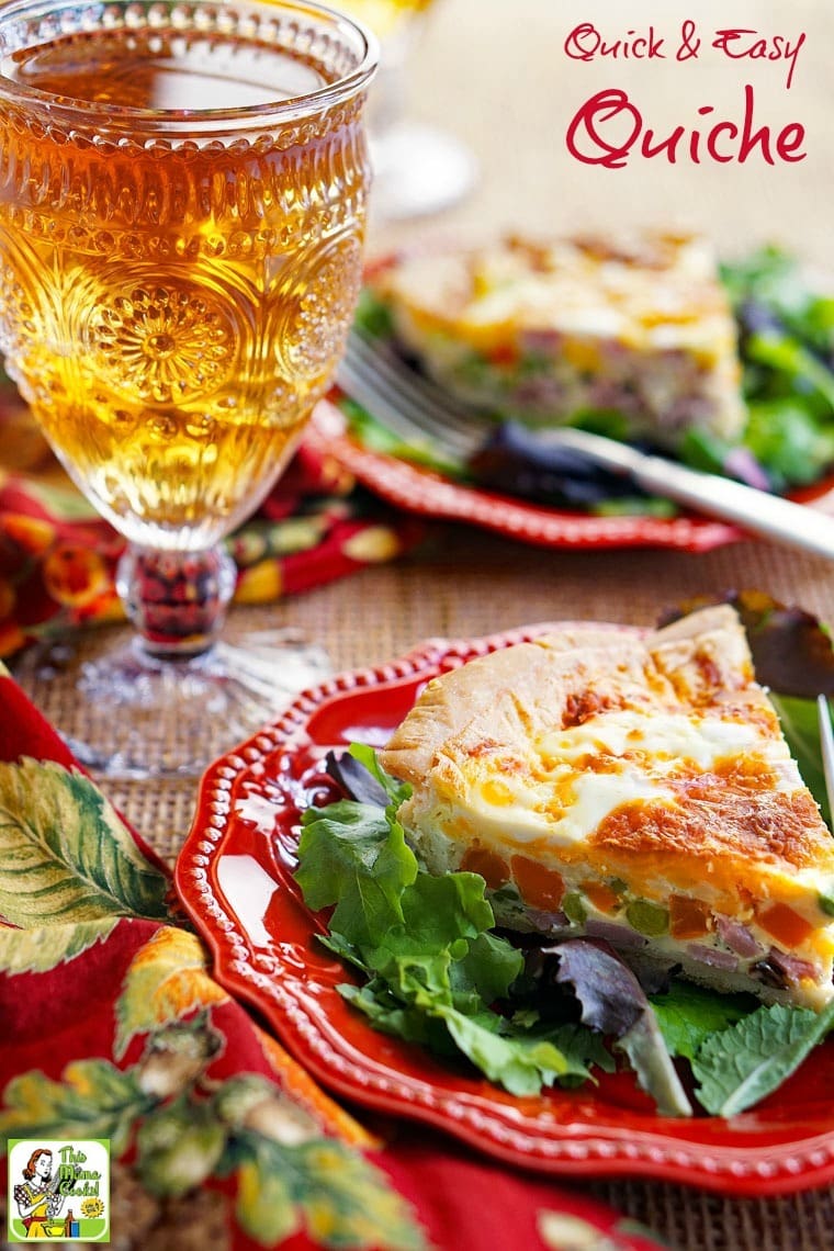 A plate of quiche with a glass of iced tea.