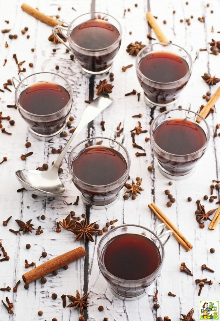 Glasses of Slow Cooker Mulled Wine with spices and ladle.