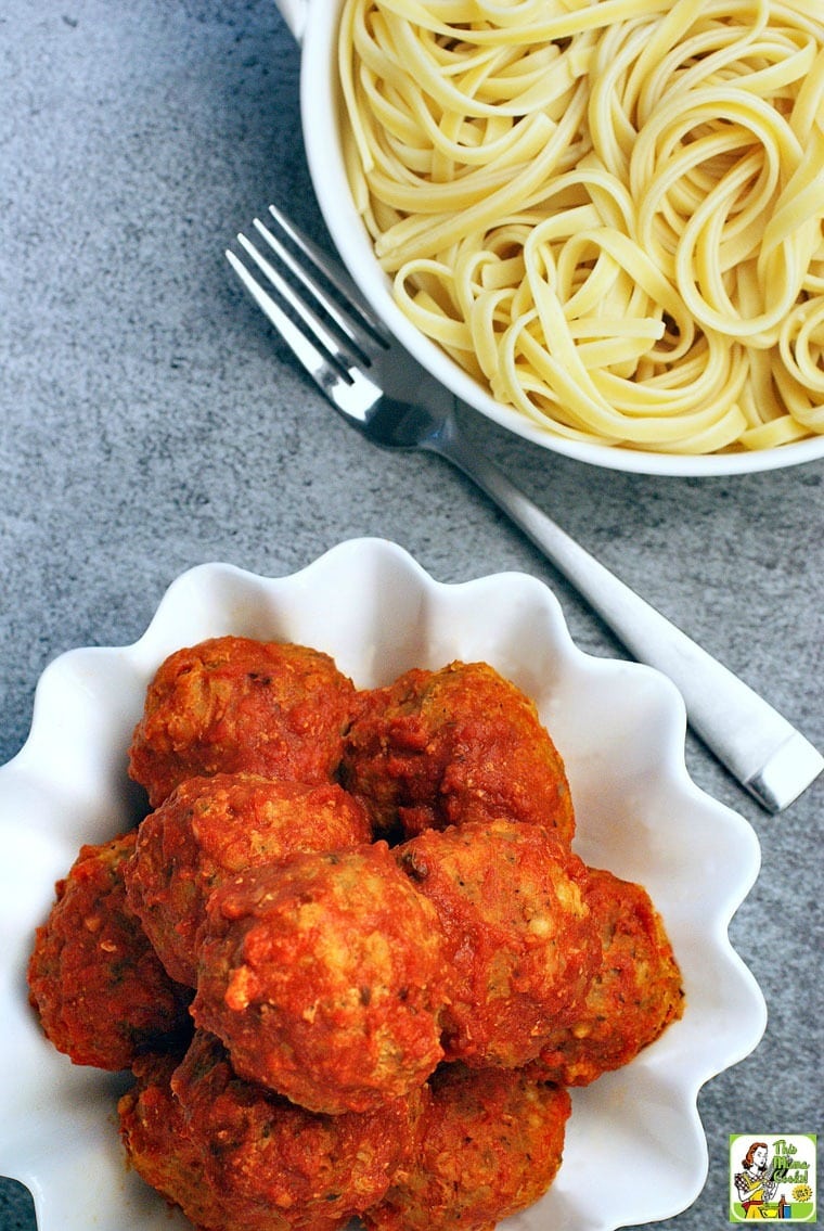 A bowl of Slow Cooker Turkey Meatballs and a bowl of pasta with a fork.