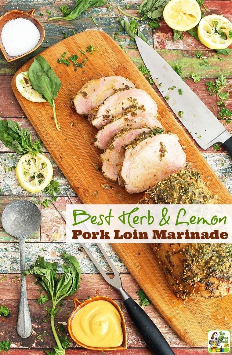 Herb & Lemon Pork Loin Marinade.  Click to get this oven pork roast on a wooden board with herbs, lemon slices, and a knife.