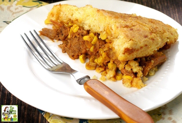 A plate of Pulled Pork Skillet with Cornbread, fork and napkin.