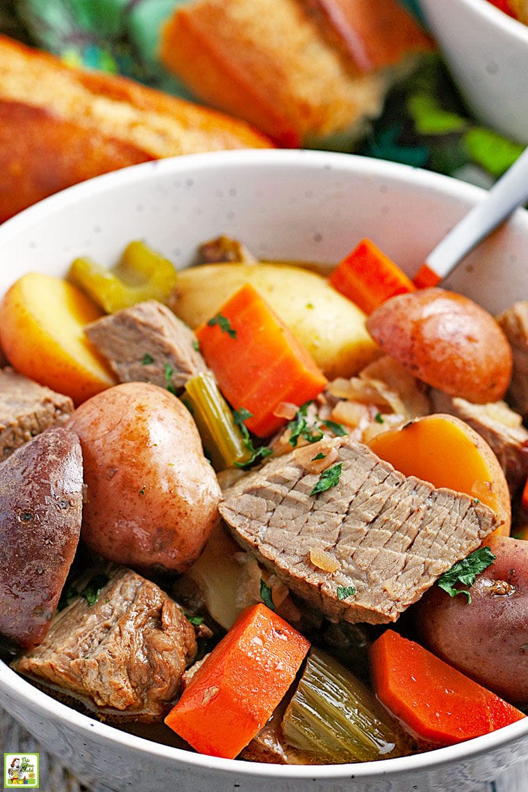 Closeup of a bowl of Slow Cooker Venison Stew with chunks of potatoes, carrots and celery.