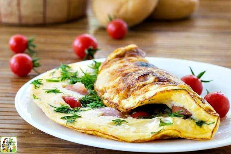 Omelette aux Fines Herbes from The Hundred-Foot Journey on a white plate with tomatoes.