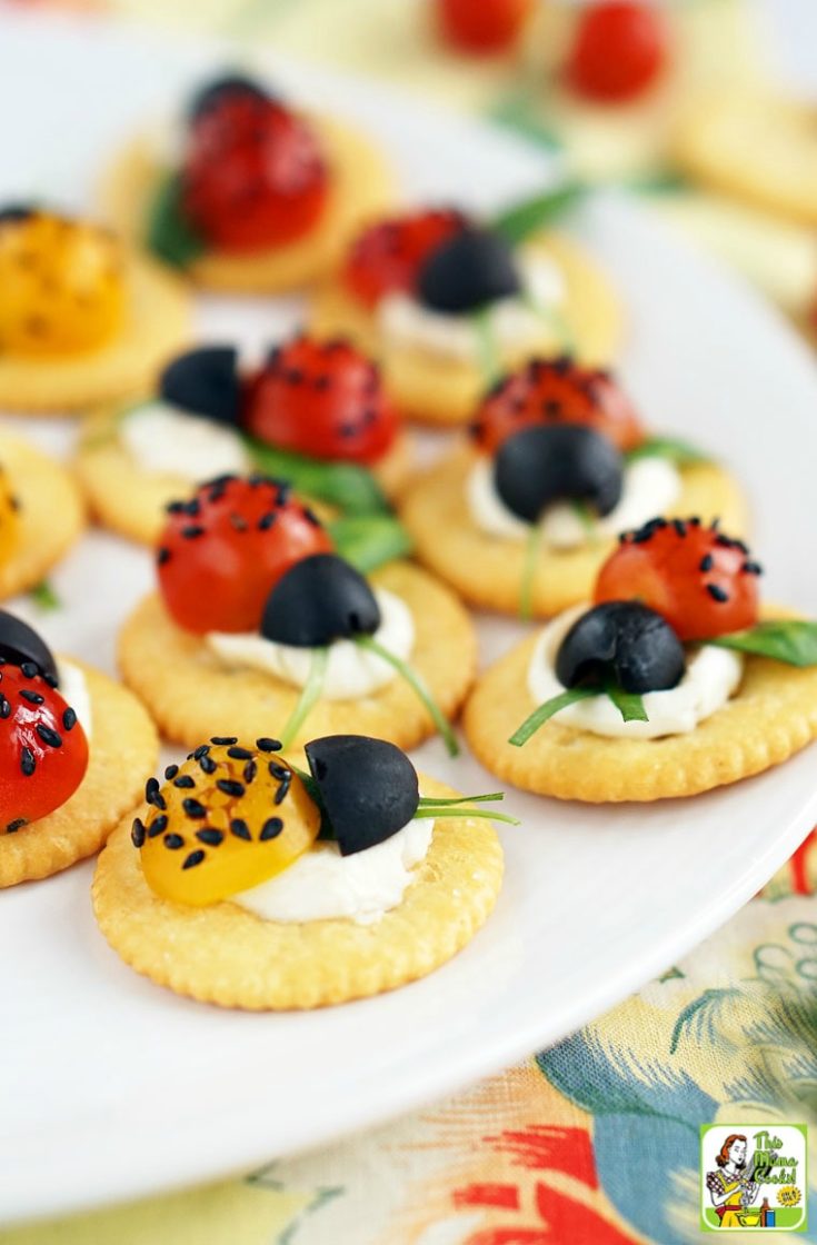 aprese Ladybugs Appetizer on a white plate with floral napkin.