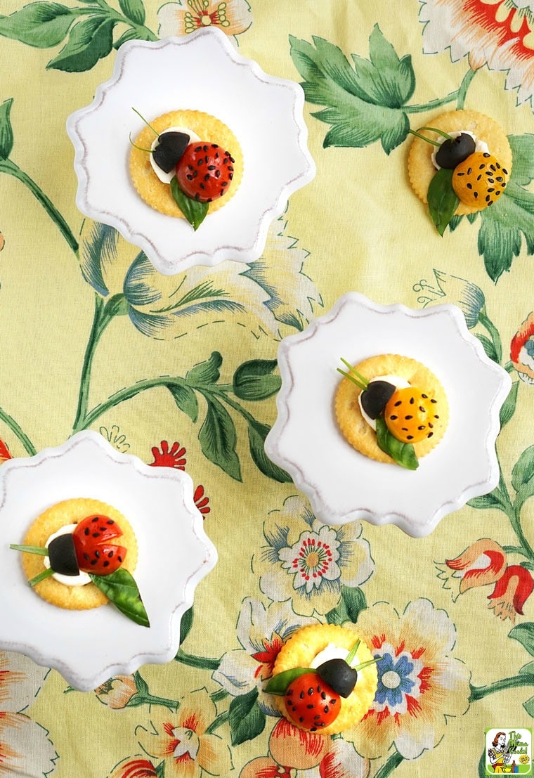 Caprese Ladybugs snack cracker appetizers on a floral napkin.