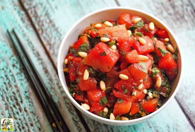 A white bowl Asian Watermelon Fruit Salad with chopsticks.