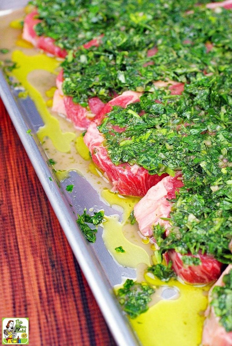 A tray of chimichurri steak to be cooked.