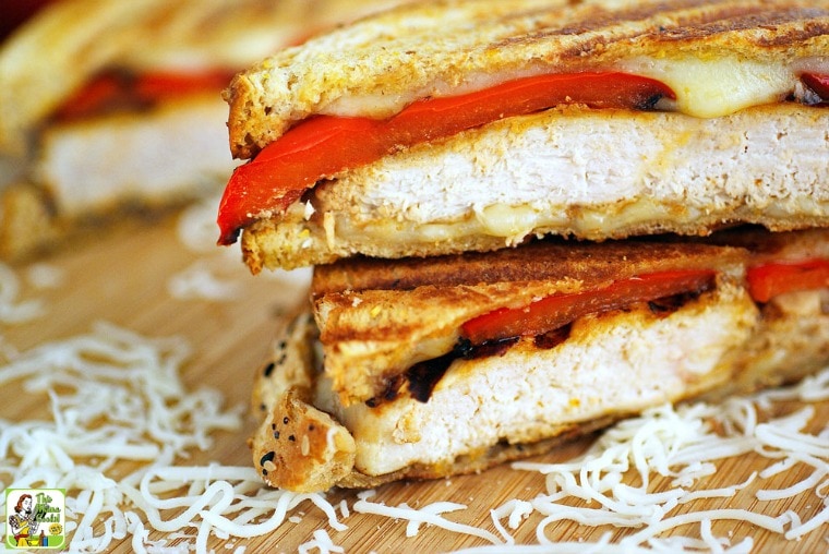 Closeup of a Chicken Panini on a wooden cutting board.