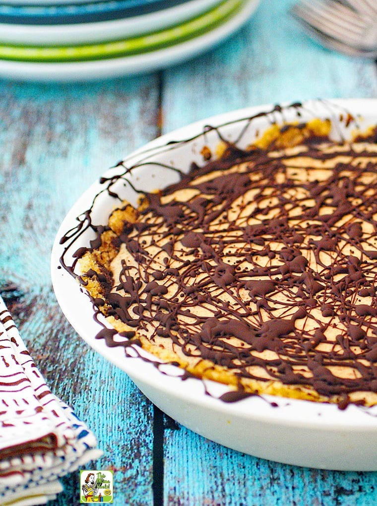 Closeup of No Bake Almond Butter Pie with chocolate drizzle and cloth napkin.