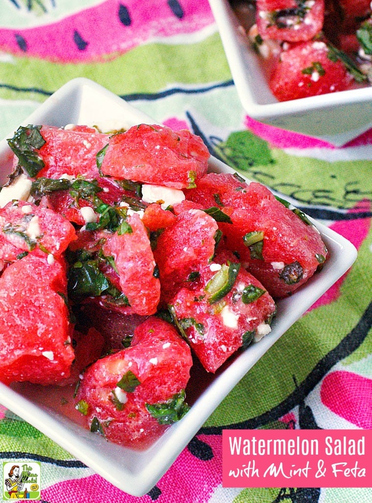 Closeup of a white square bowl of Watermelon Salad with Mint & Feta on a watermelon printed napkin.