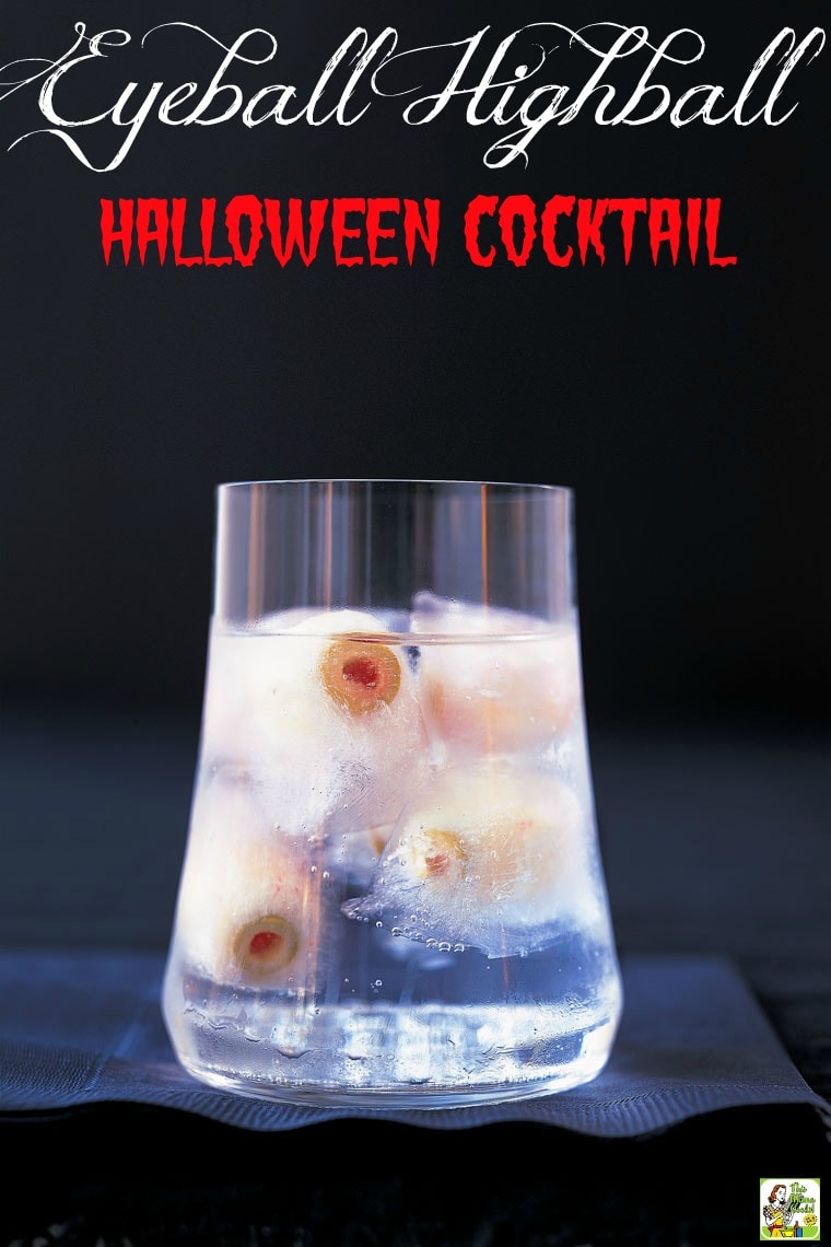 A glass of Halloween Martini highball drink recipe on a stack of black napkins.