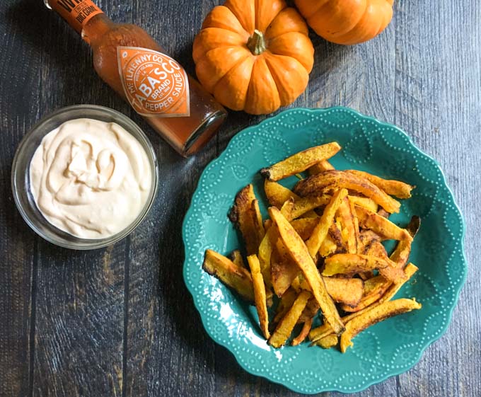 Turquoise plate of Pumpkin Fries with Buffalo Aioli in a side dish.