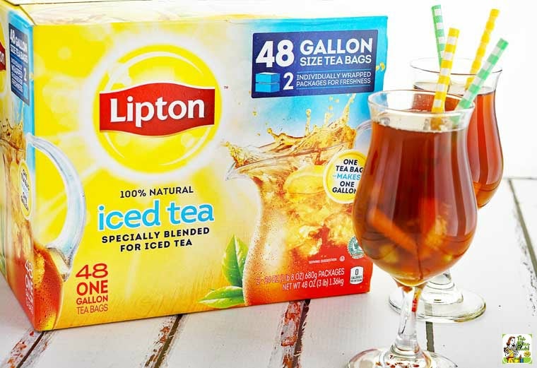A box of Lipton Iced Tea and two glasses of iced tea with yellow and green straws.