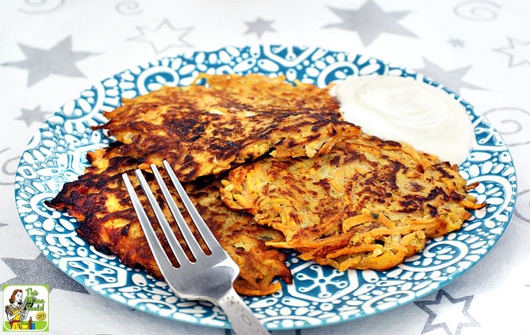 A plate of Sweet Potato Pancakes with Greek yogurt and a fork.