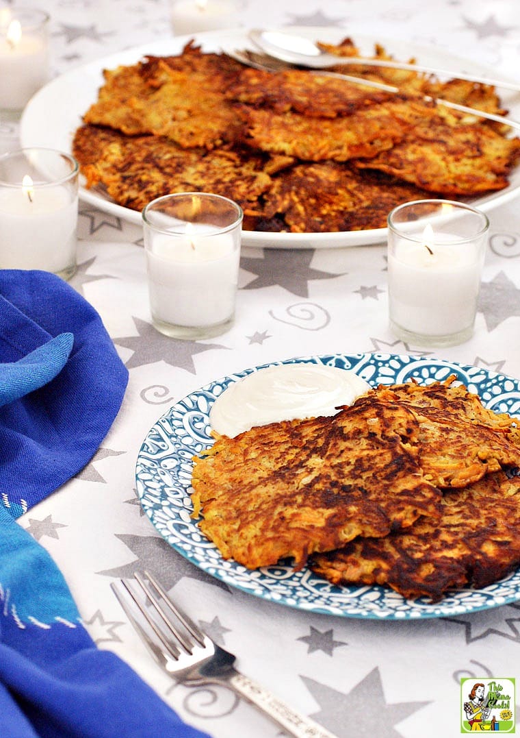 Plates Sweet Potato Pancakes with candles and a blue napkin.