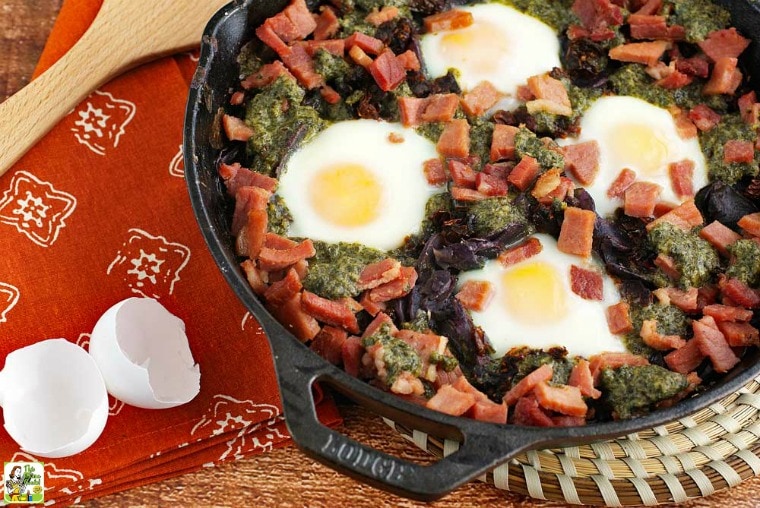 Baked Eggs with Skillet Potatoes in Pesto, wood spatual, napkin, and egg shells.