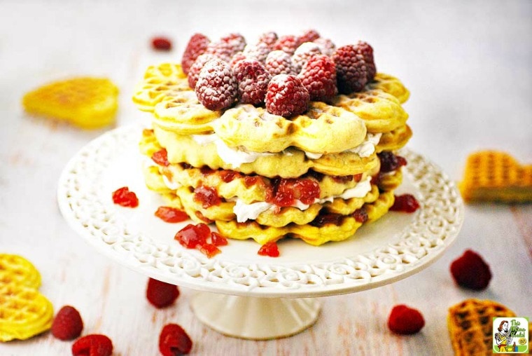 A Gluten Free Waffle Cake on a white cake stand.