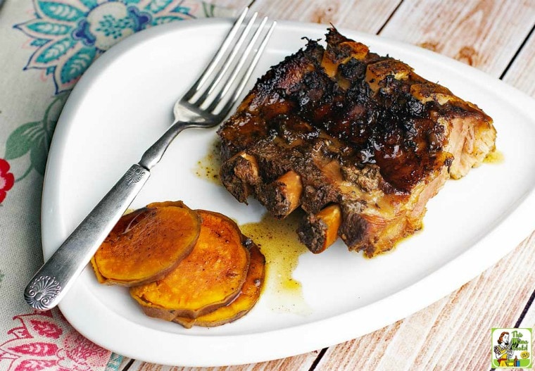 A plate of Crock-Pot Ribs with Balsamic & Sorghum and slices of sweet potatoes.