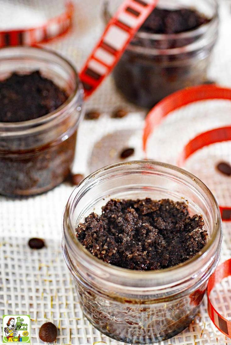 Jars of homemade coffee sugar scrub with striped ribbon and coffee beans.