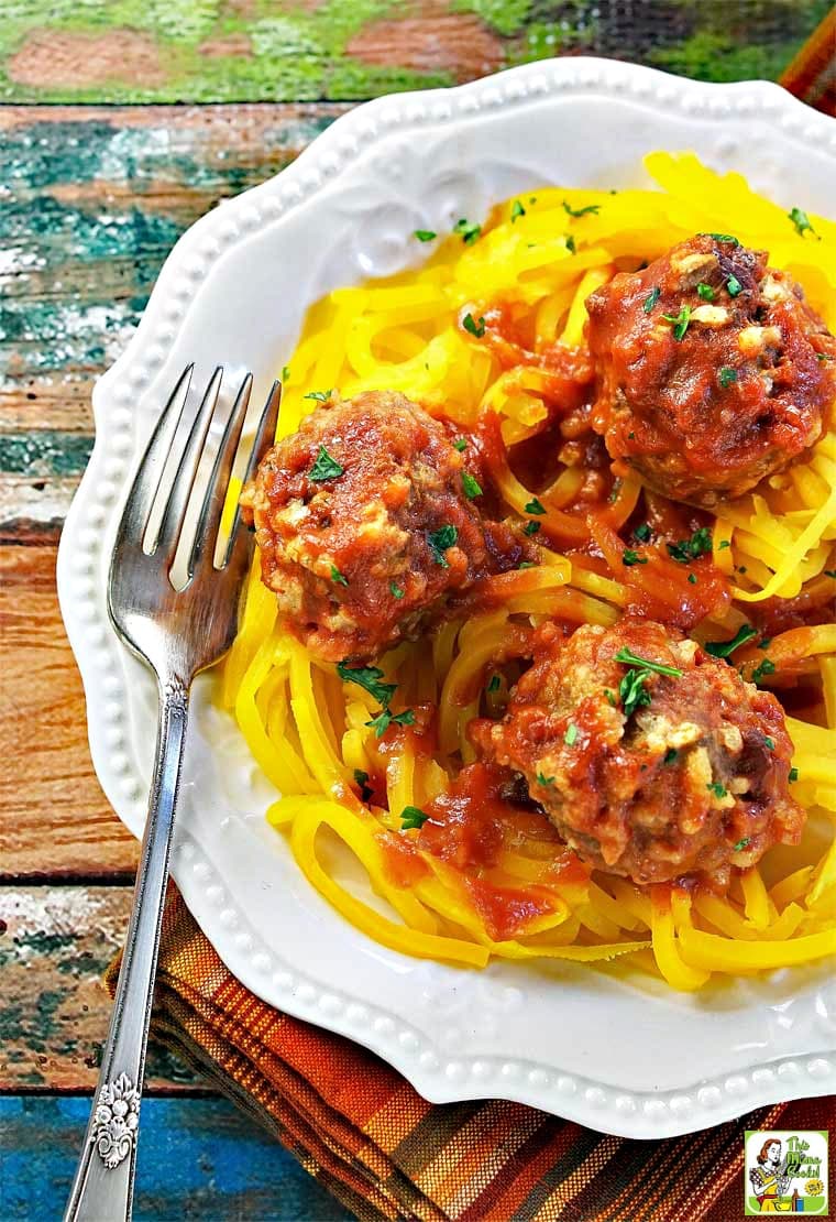 A white plate of porcupine meatballs served on squash noodles.