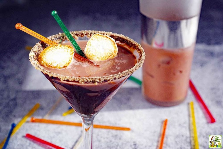 A glass of Smores Martini with cocktail shaker and sizzle sticks.