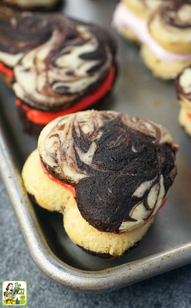 Closeup of chocolate and vanilla cake mix whoopie pies on a baking sheet pan.