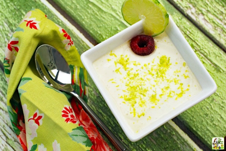 A bowl of vegan key lime mousse with spoon and floral napkin.