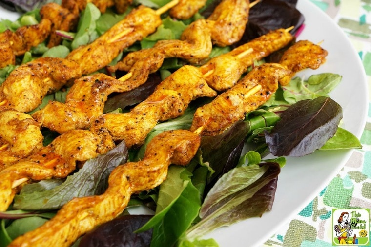 A platter of Chicken Shawarma Appetizers with Dipping Sauce on lettuce leaves.