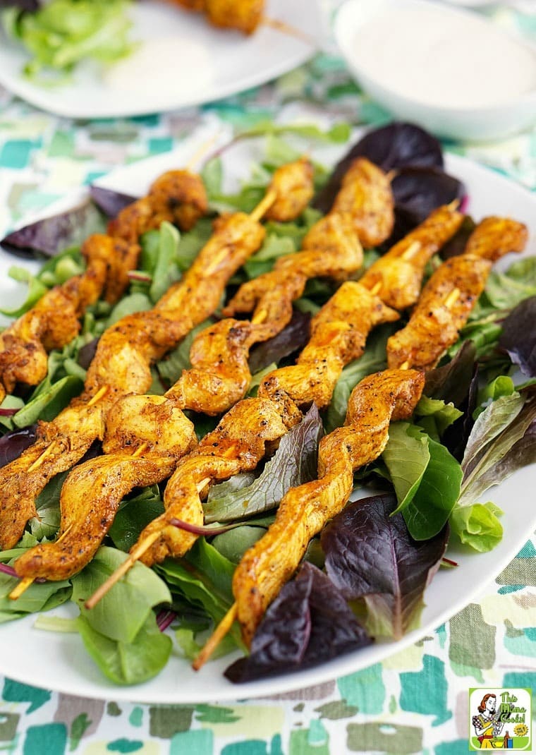 A plate of Chicken Shawarma Appetizers with a dish of dipping sauce in the background.