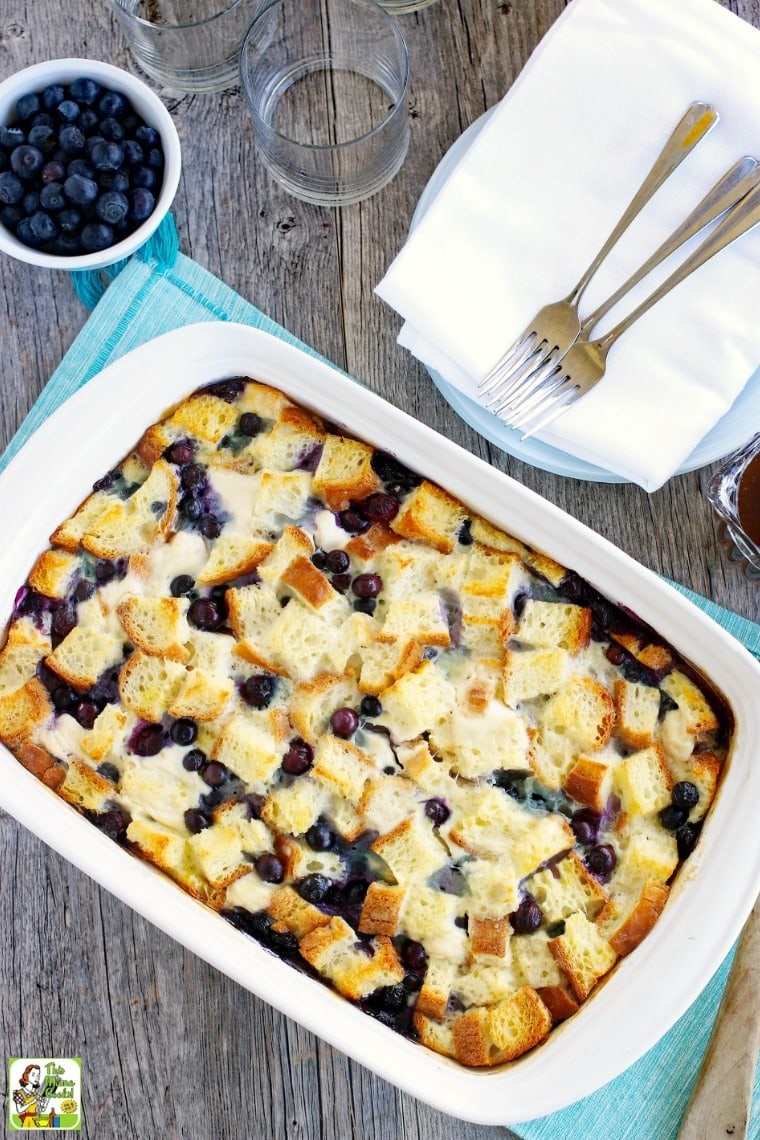 Large white casserole of French toast bake on a blue placemat.