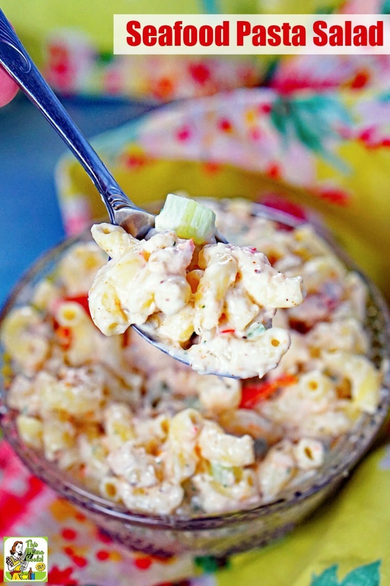 A spoonful of Seafood Pasta Salad above a bowl.