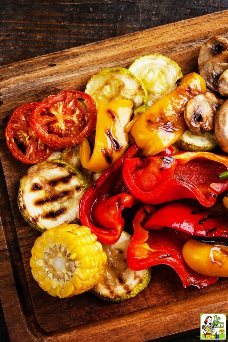 A wooden platter of Roasted Marinated Vegetables.