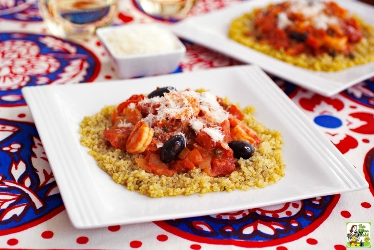 Shrimp Puttanesca with Quinoa Recipe in white bowls on a red, white and blue tablecloth.