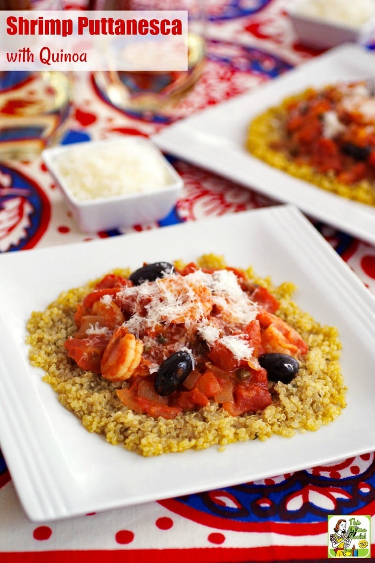 A white bowl of Shrimp Puttanesca with Quinoa on a colorful tablecloth.